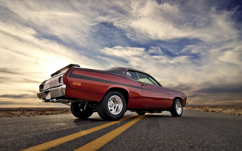 Red muscle car on desert road