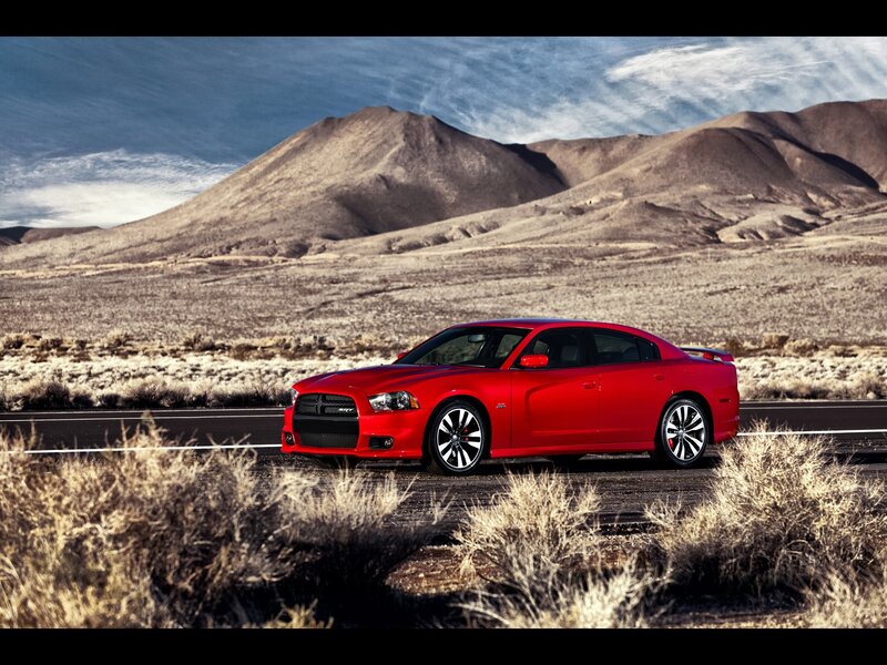 Red muscle car on desert road