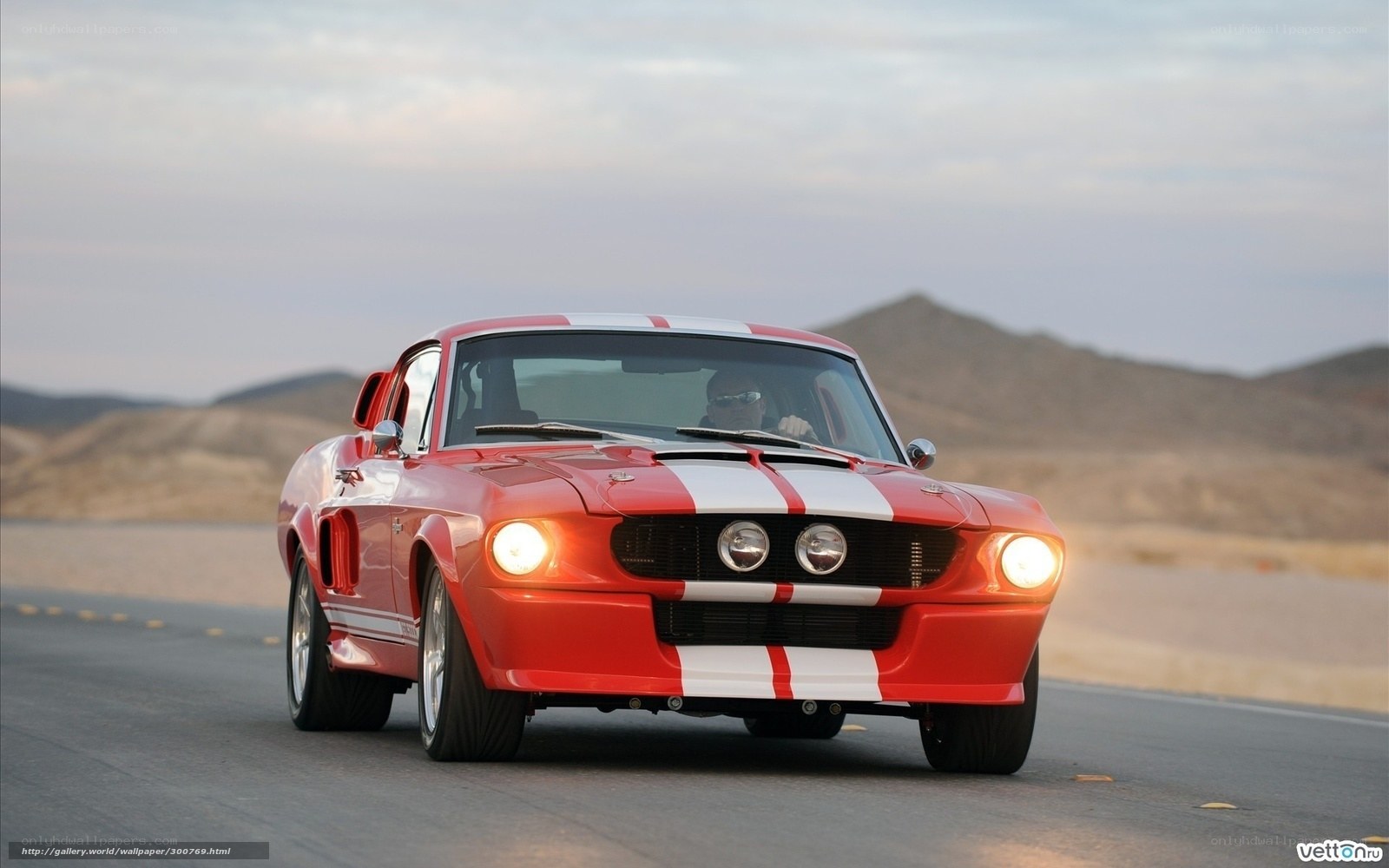 Red muscle car on desert road