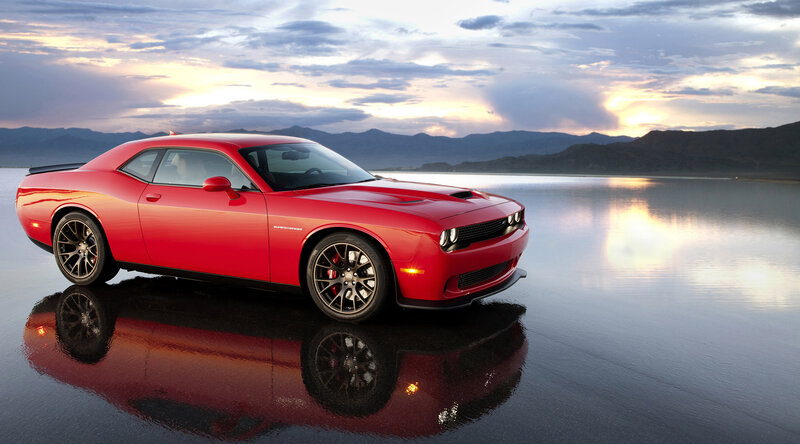 Red muscle car on wet surface