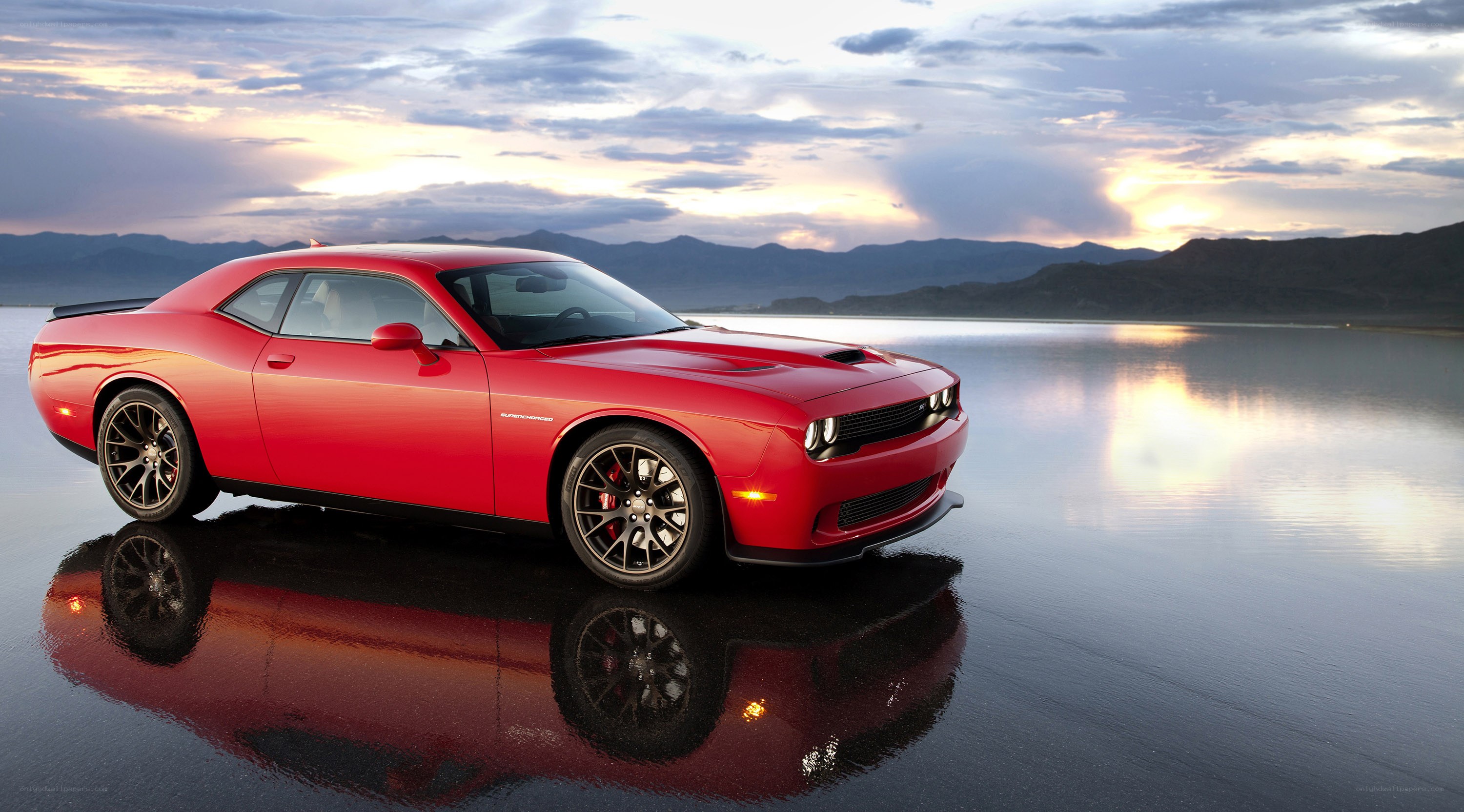 Red muscle car on wet surface