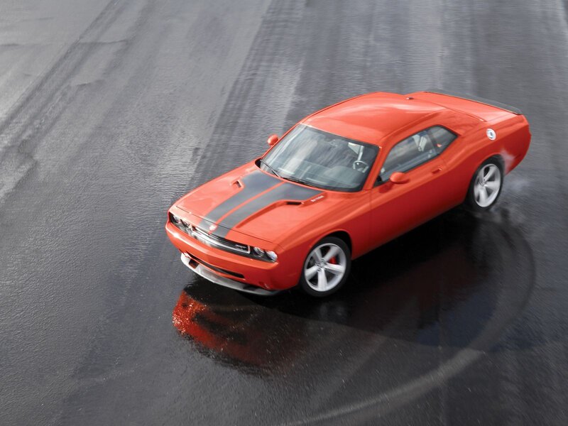 Red muscle car on wet track