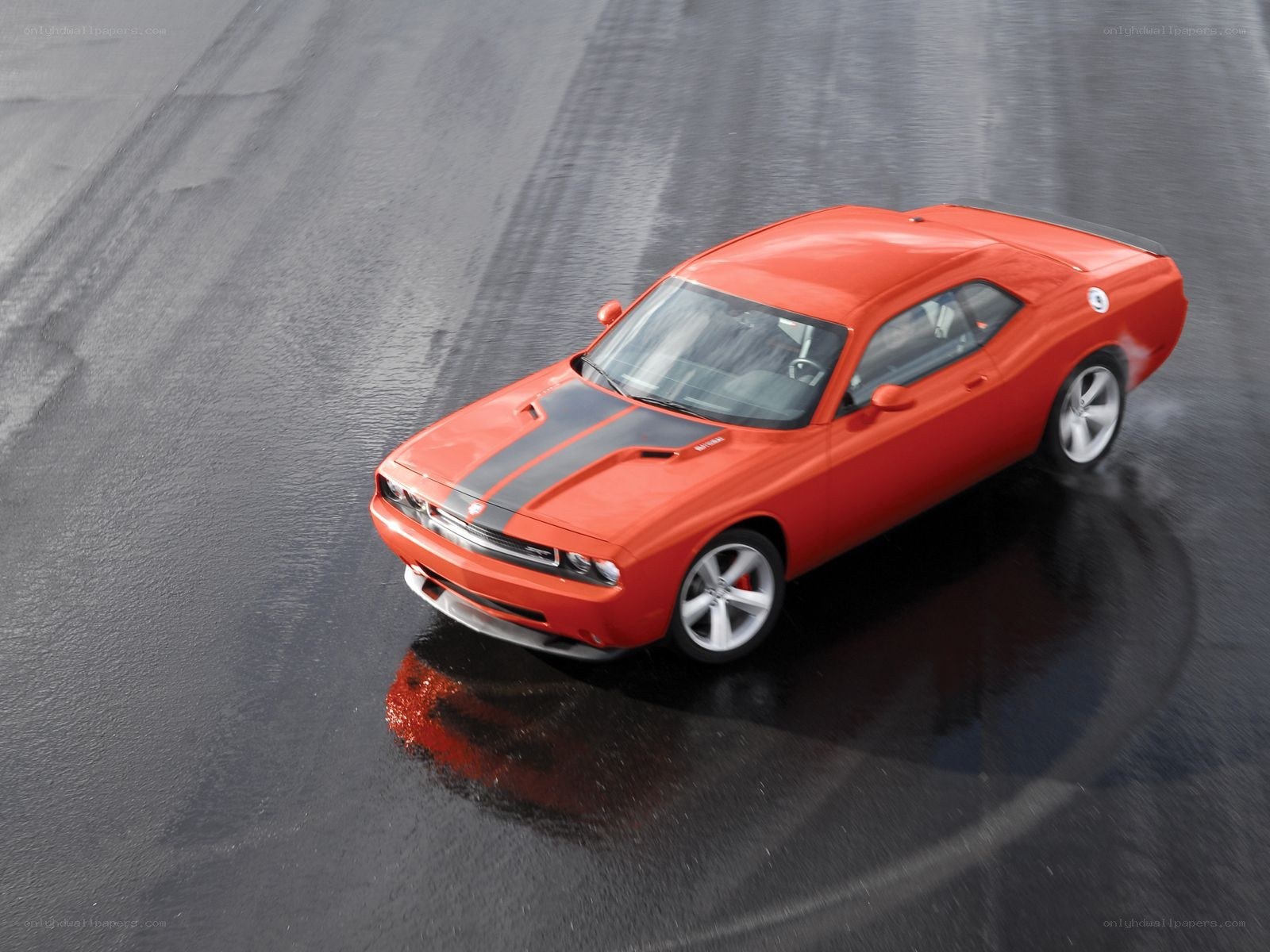Red muscle car on wet track