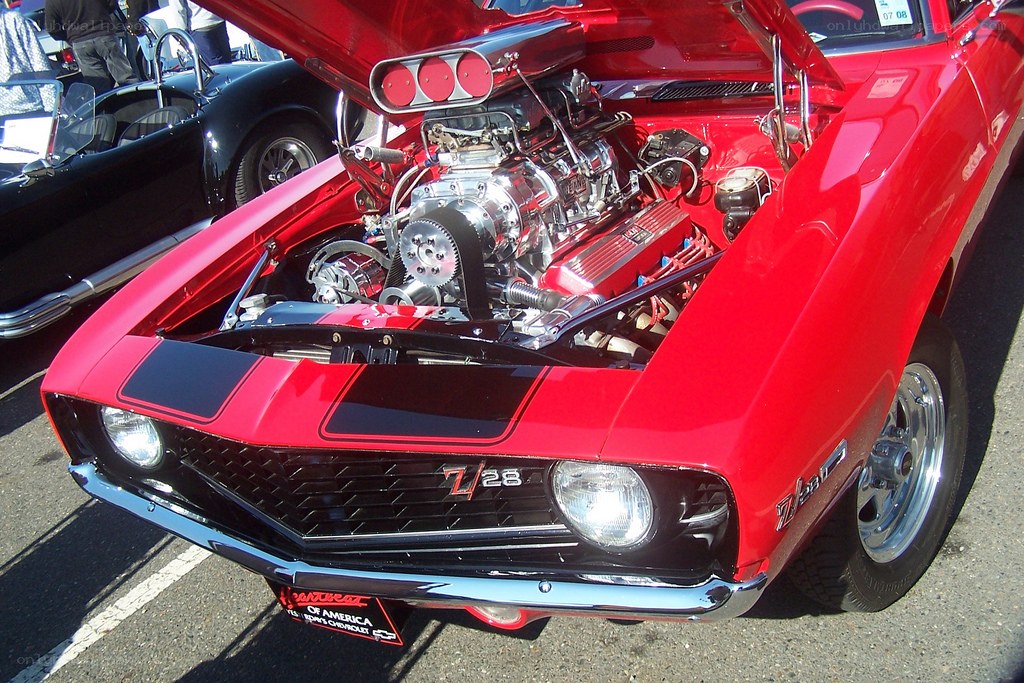 Red muscle car with open hood