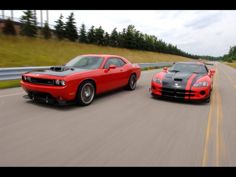 Red muscle cars on a road