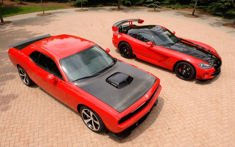 Red muscle cars on pavement