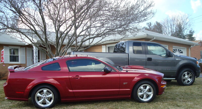 Red Mustang and gray truck