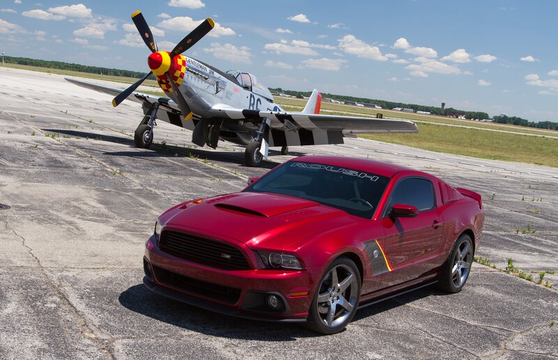 Red Mustang and vintage plane