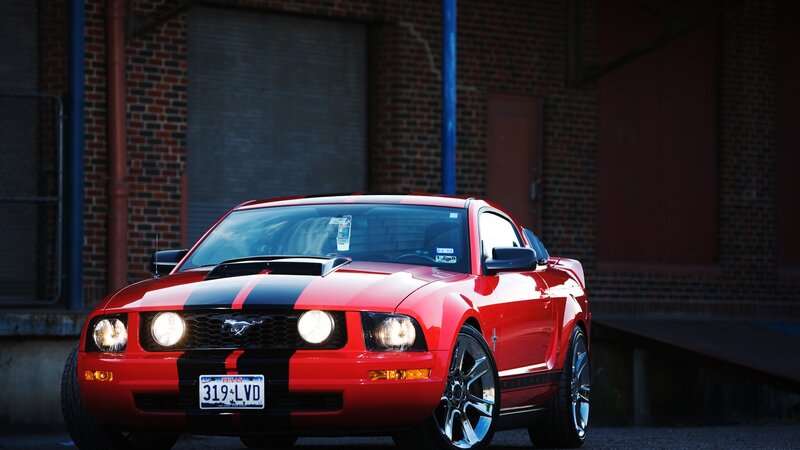 Red Mustang Car — Dramatic, Night, Photograph, Brick Building, License Plate, Headlights