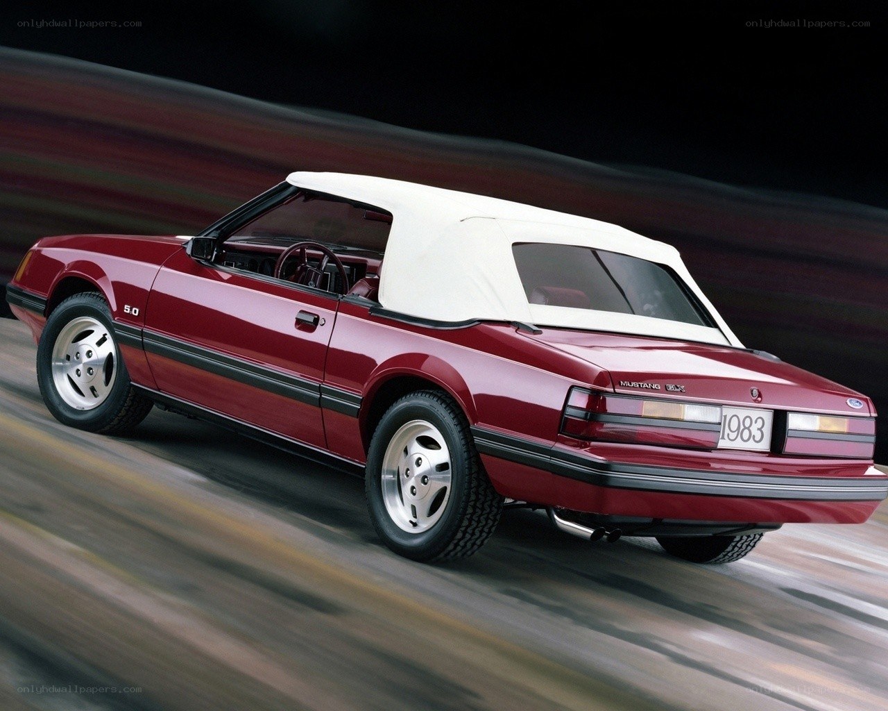 Red Mustang convertible in motion