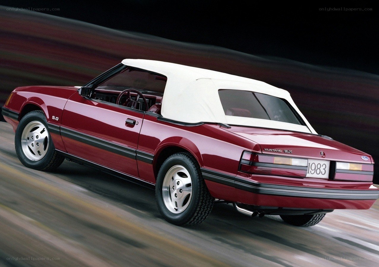 Red Mustang convertible in motion