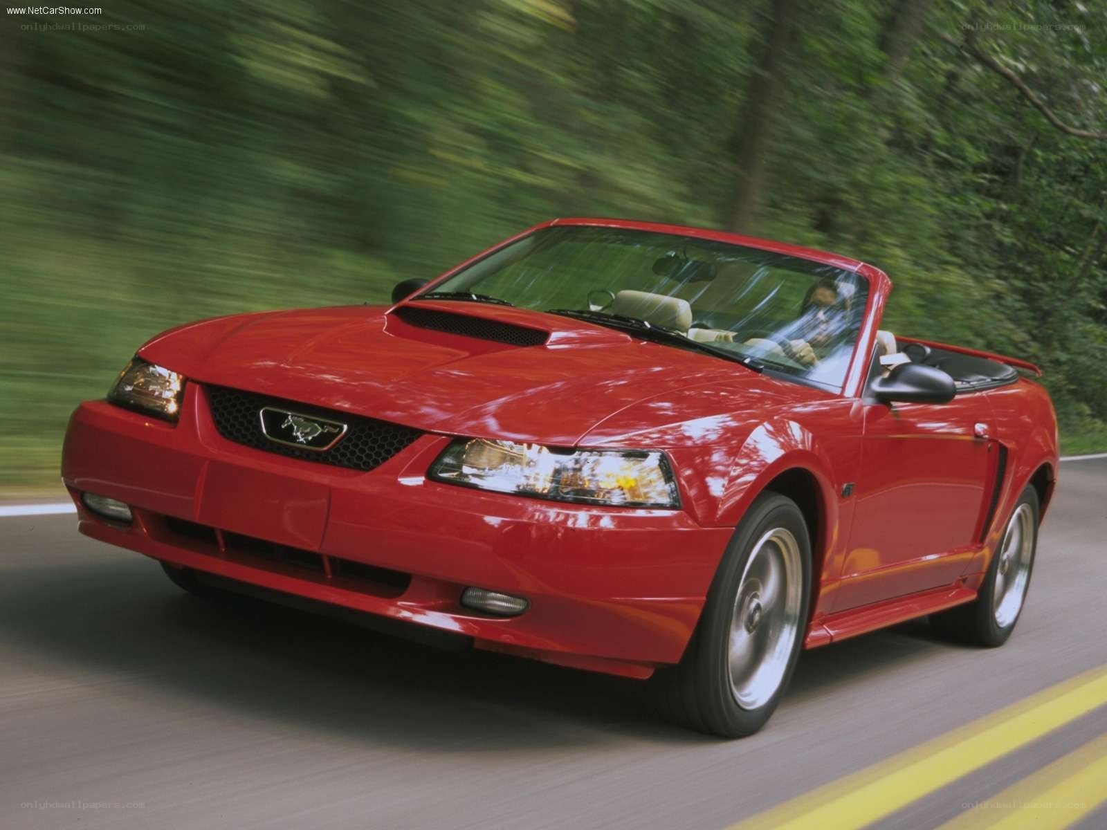 Red Mustang convertible in motion