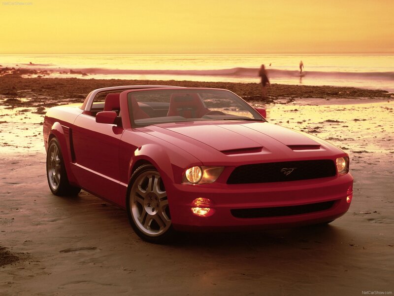Red Mustang convertible on beach