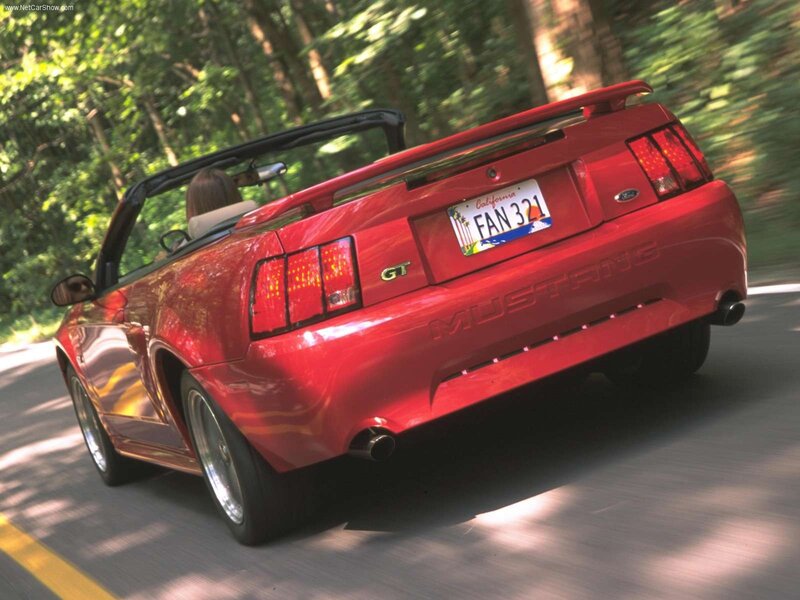 Red Mustang convertible on road