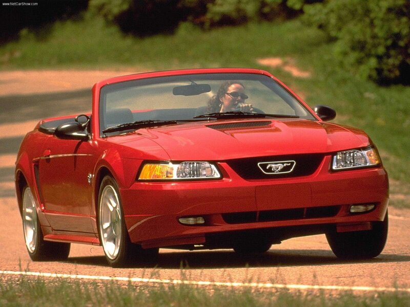 Red Mustang convertible on road
