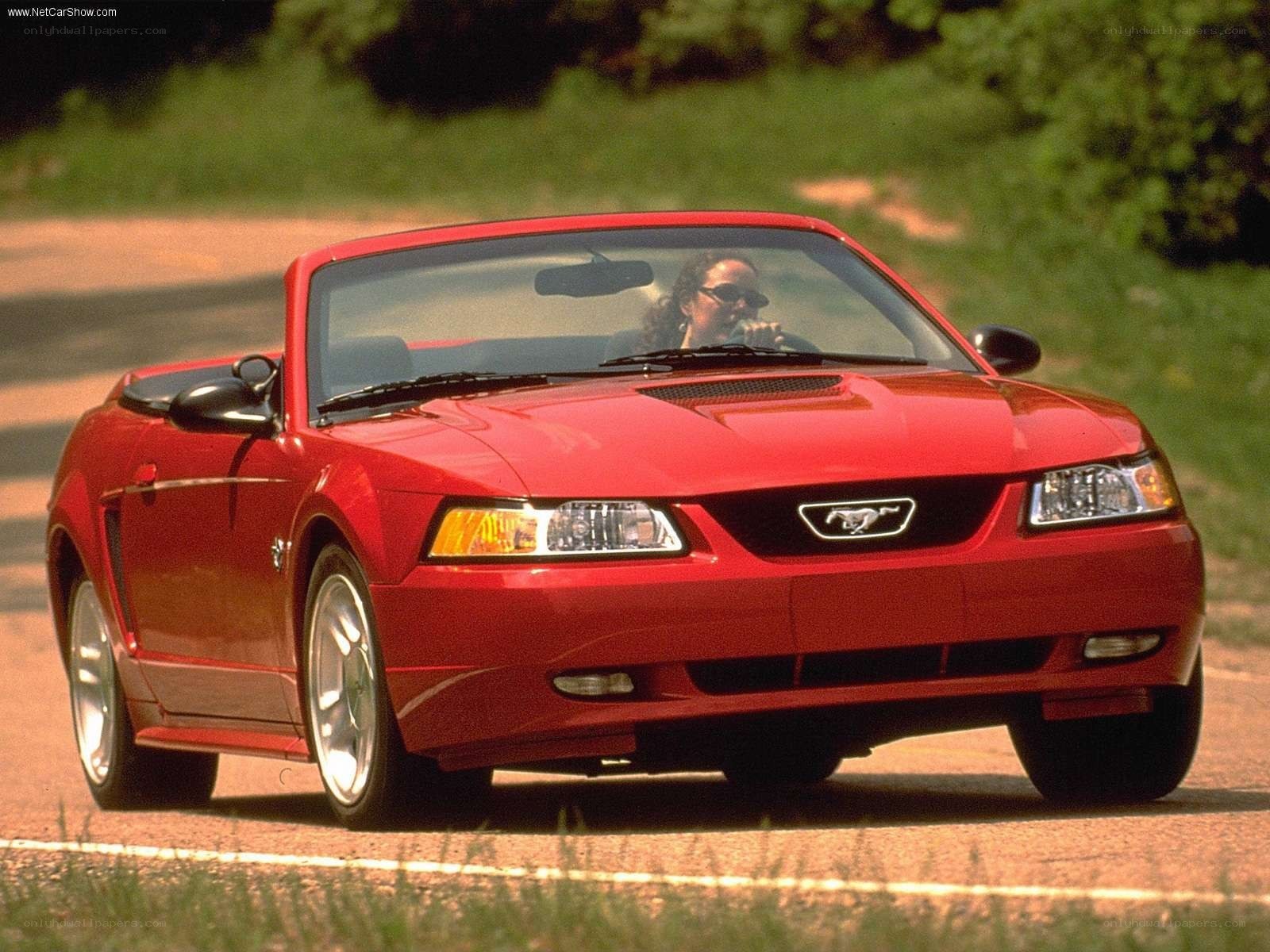 Red Mustang convertible on road