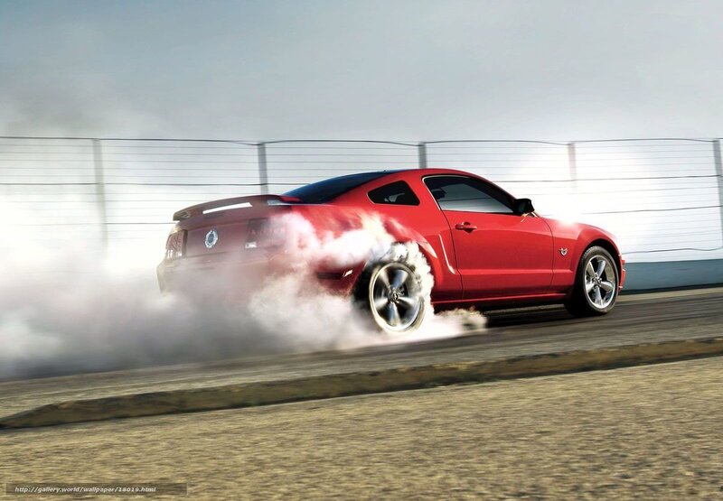 Red Mustang drifting on track