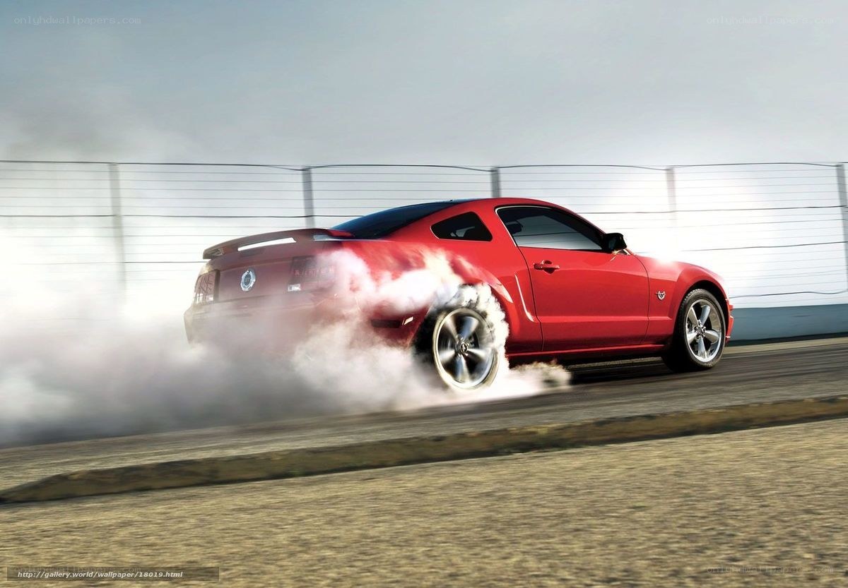 Red Mustang drifting on track