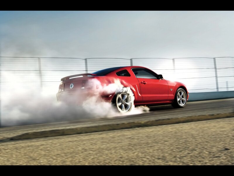 Red Mustang drifts on track