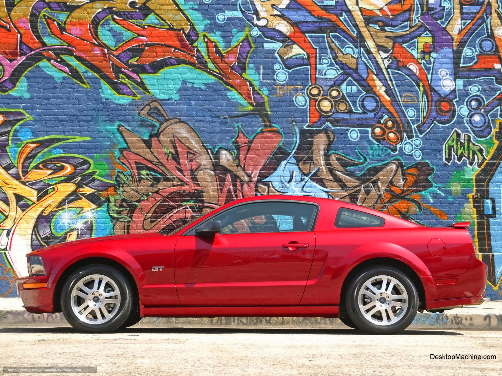 Red Mustang GT in front of graffiti wall