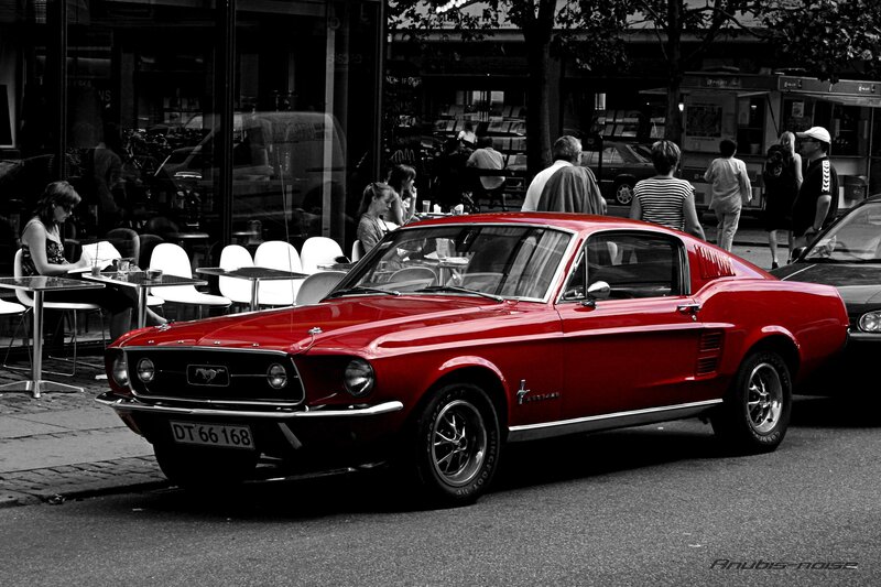 Red Mustang on a city street