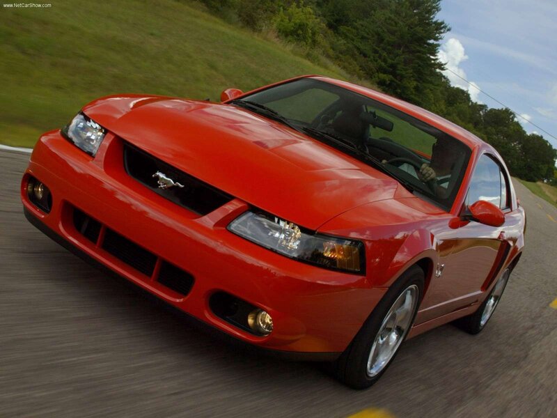 Red Mustang on a country road