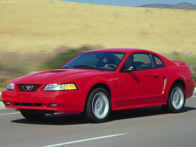 Red Mustang on a road