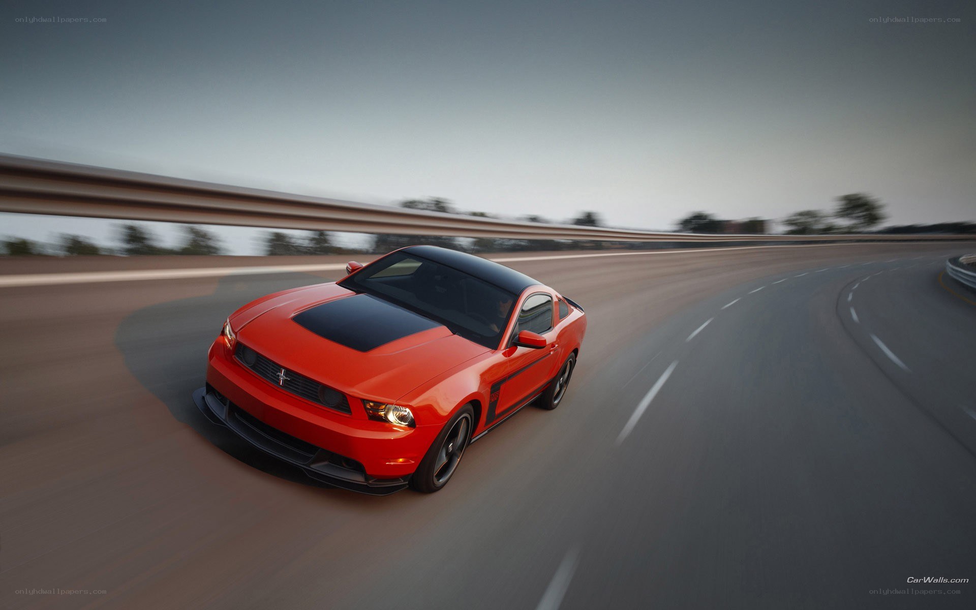 red mustang on a winding road