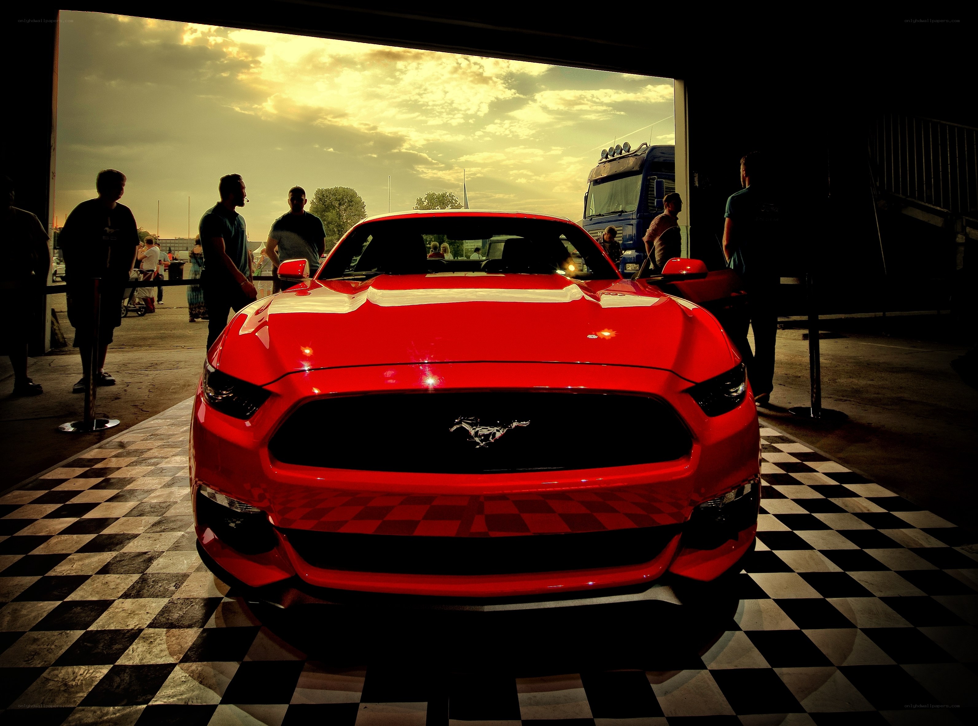 Red Mustang on checkered floor