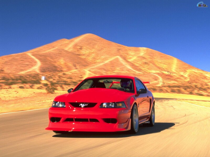 Red Mustang on desert road