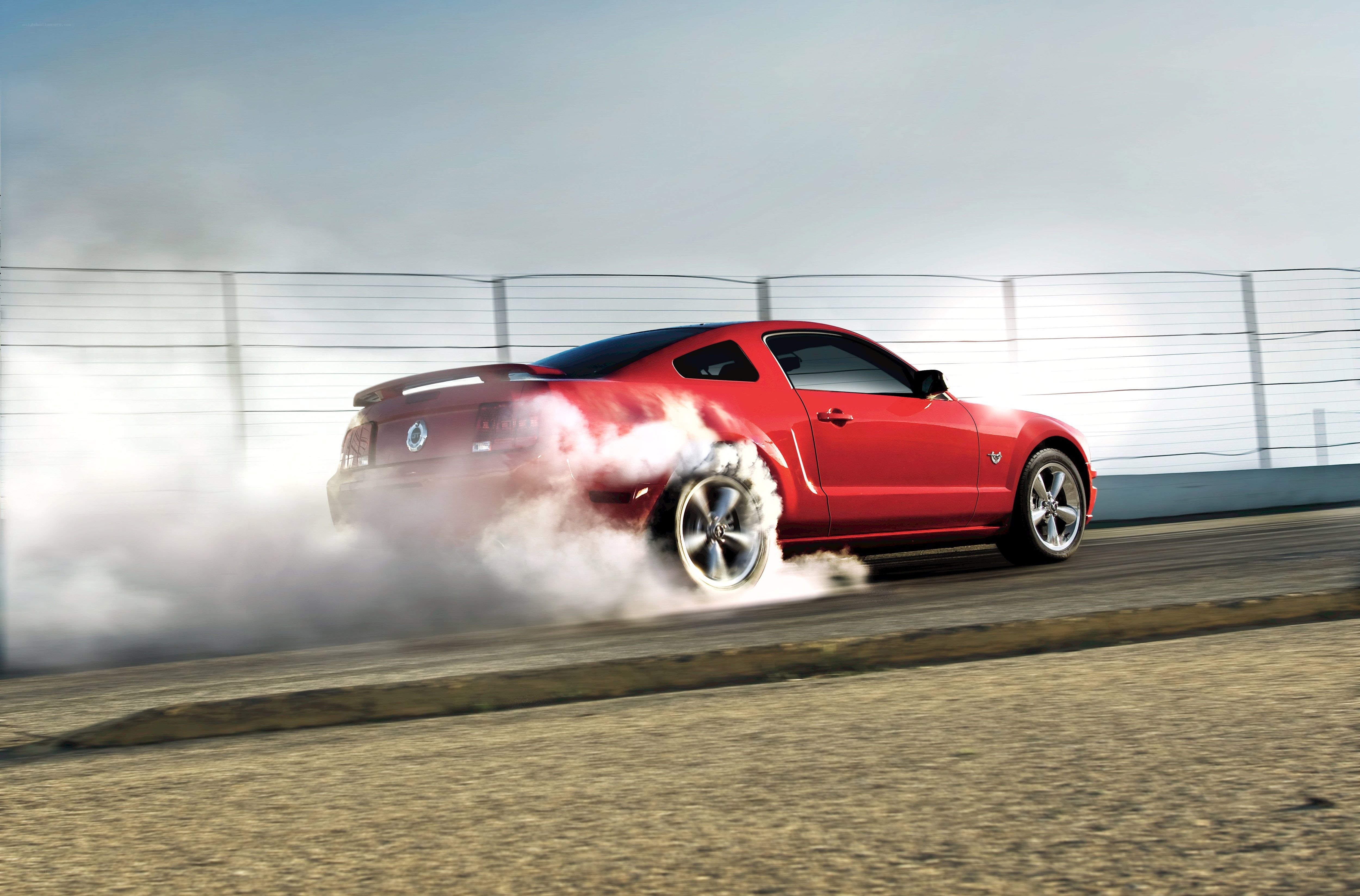Red Mustang performing burnout