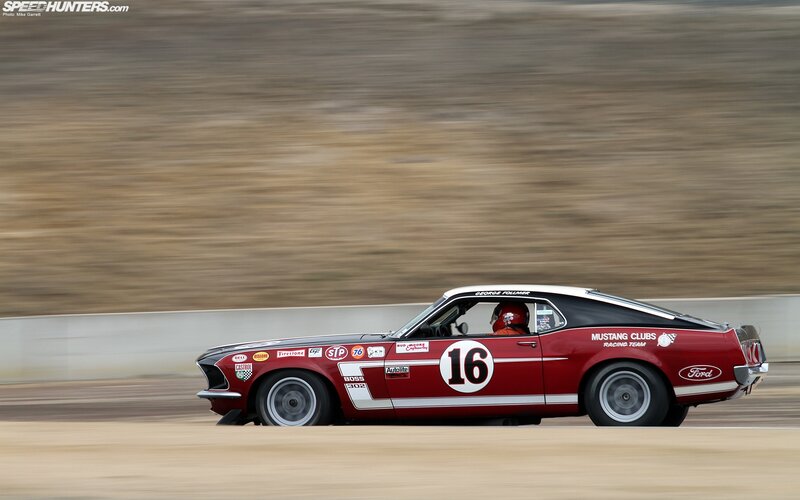 Red Mustang racing on track