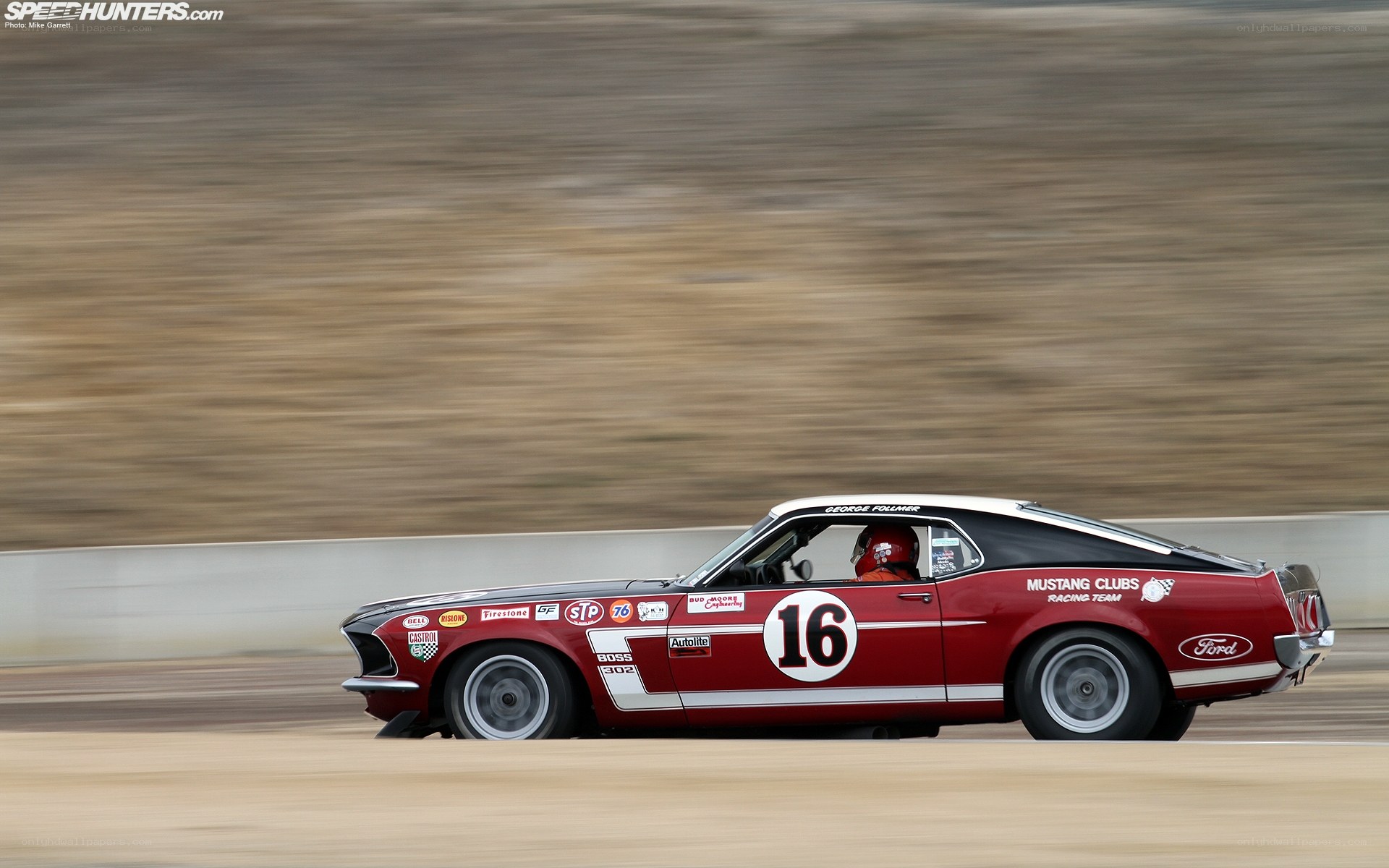 Red Mustang racing on track