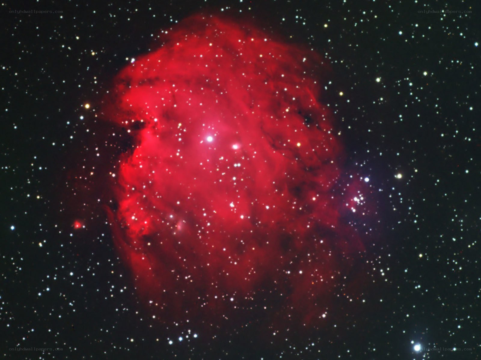 Red nebula in star field