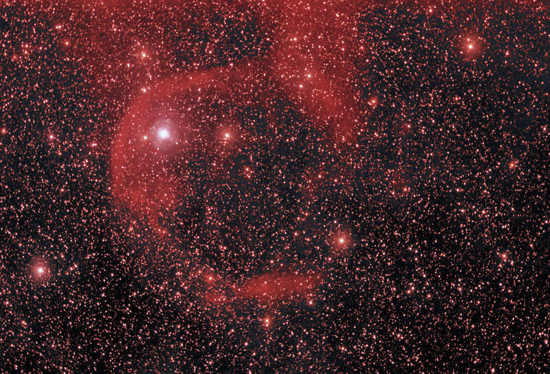 Red nebula in star field