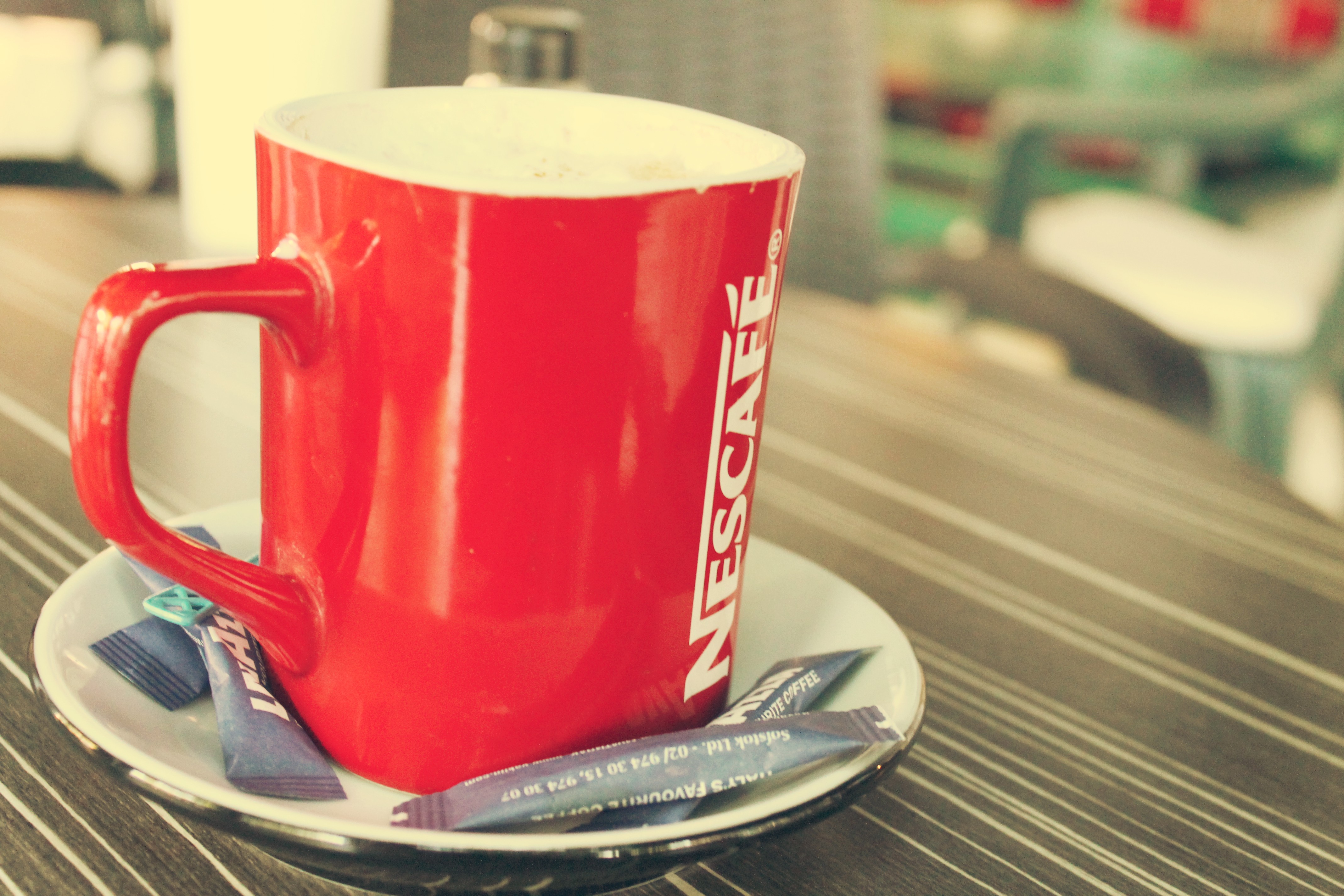 Red Nescafe mug on table