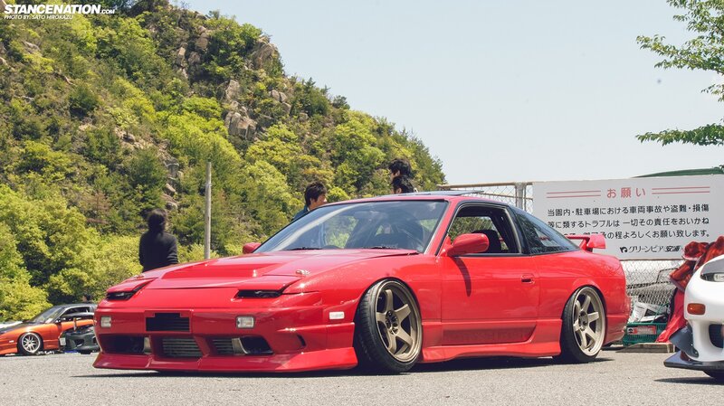 Red Nissan 180SX at outdoor car show