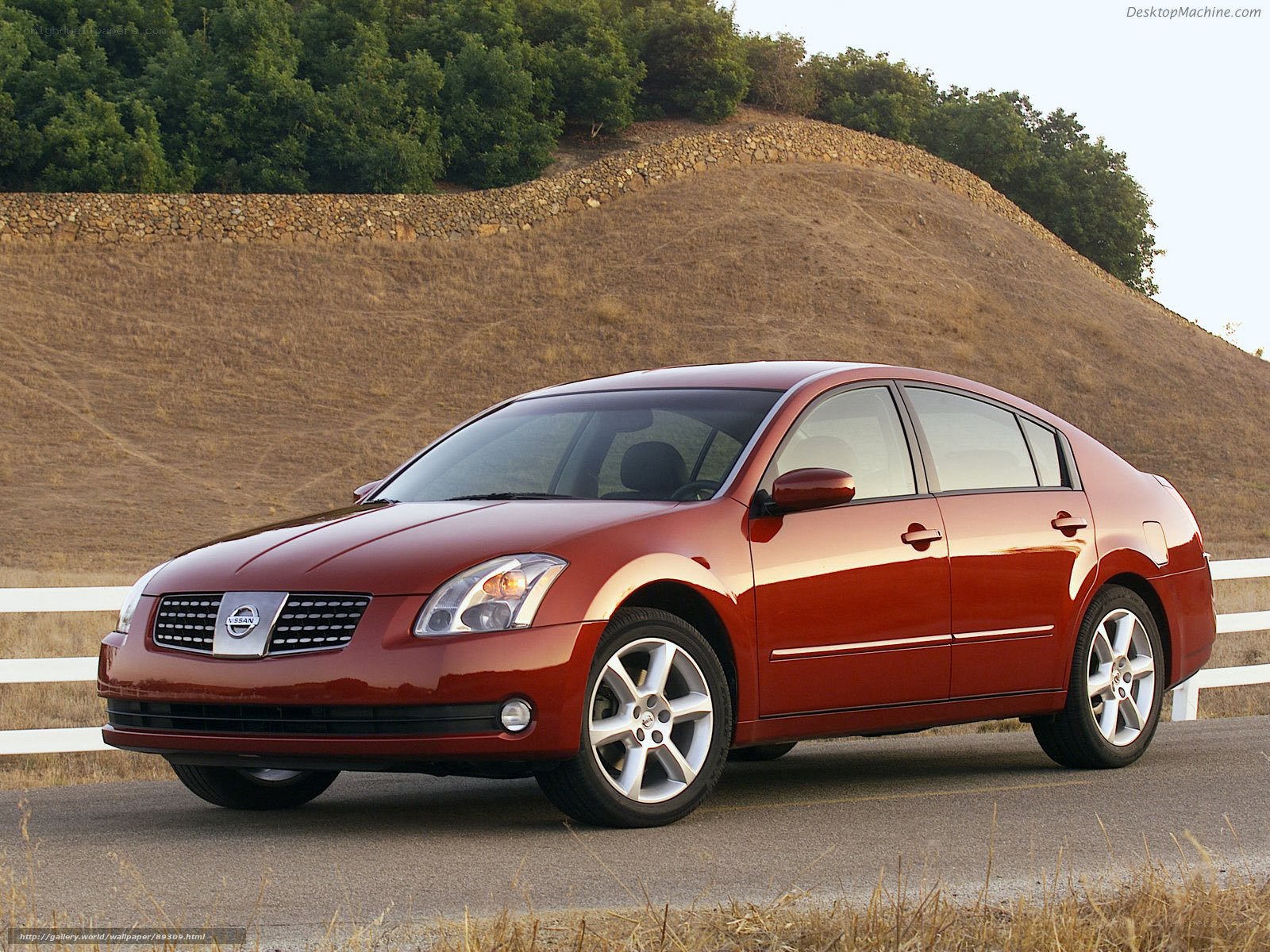 Red Nissan Altima on a country road