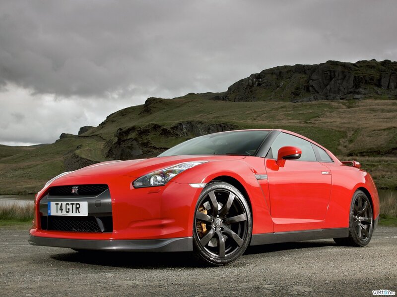 Red Nissan GT-R on a gravel road