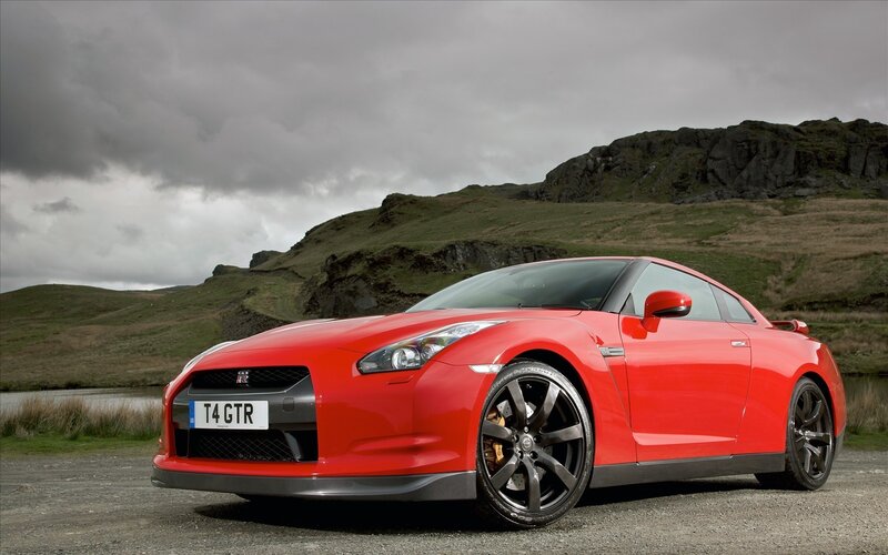 Red Nissan GT-R on a gravel road