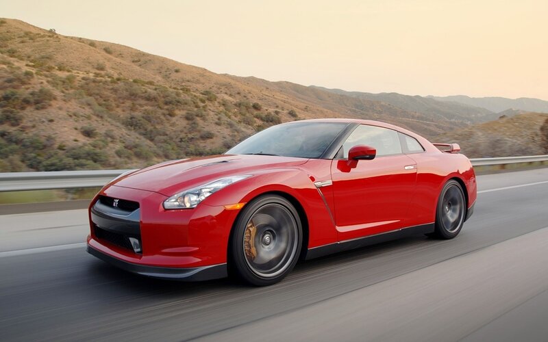 Red Nissan GT-R on a mountain road