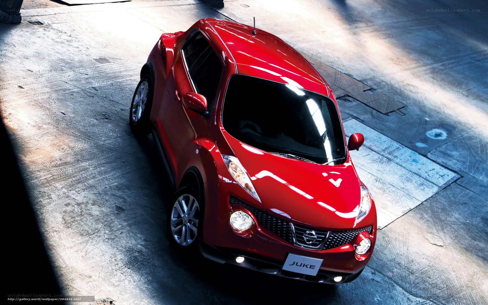 Red Nissan Juke in a garage
