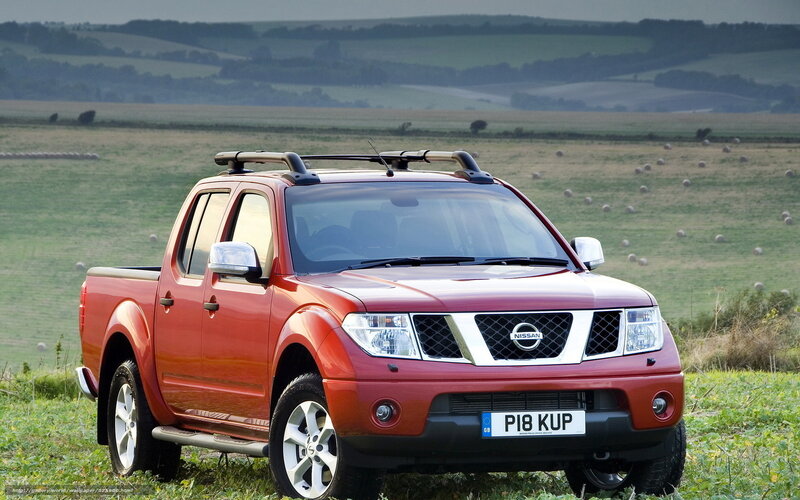 Red Nissan Navara in a field