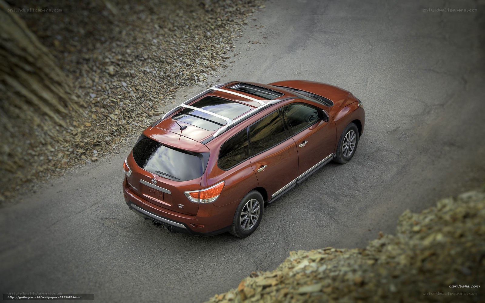 Red Nissan Pathfinder on road