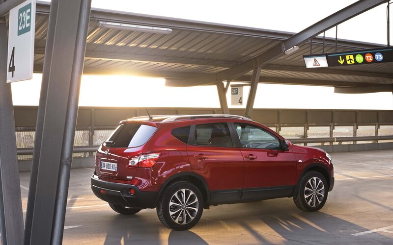 Red Nissan Qashqai at airport terminal