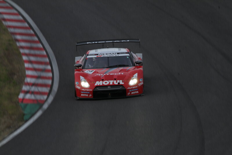 Red Nissan race car on track