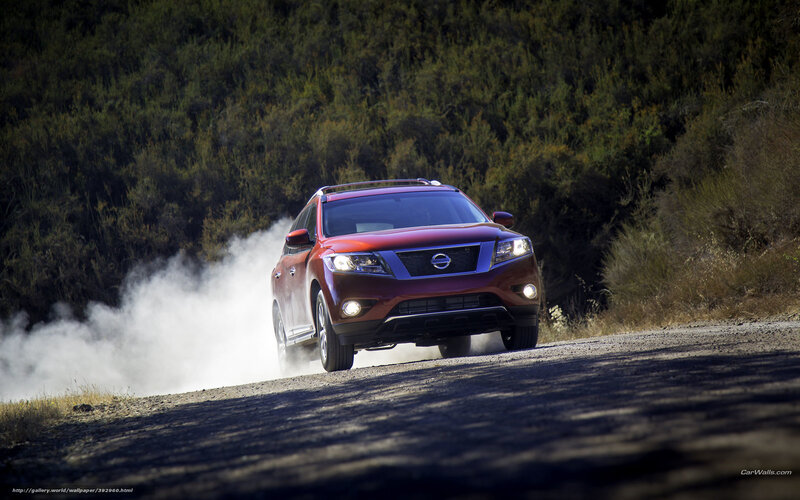 Red Nissan Rogue on dirt road
