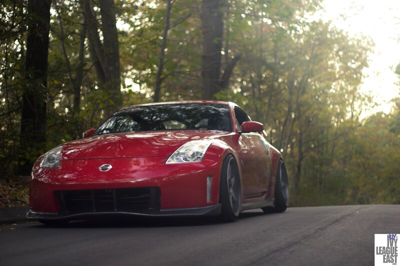 Red Nissan sports car on a forest road