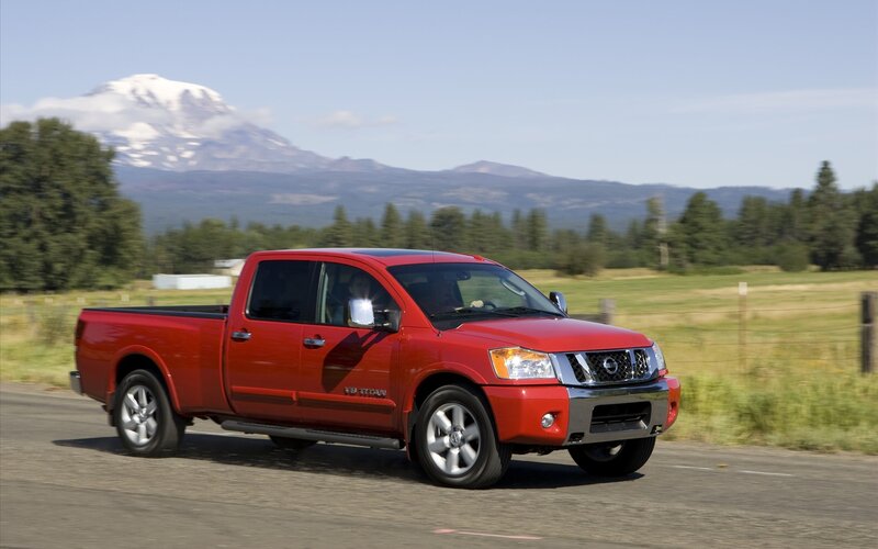 Red Nissan Titan on a scenic road