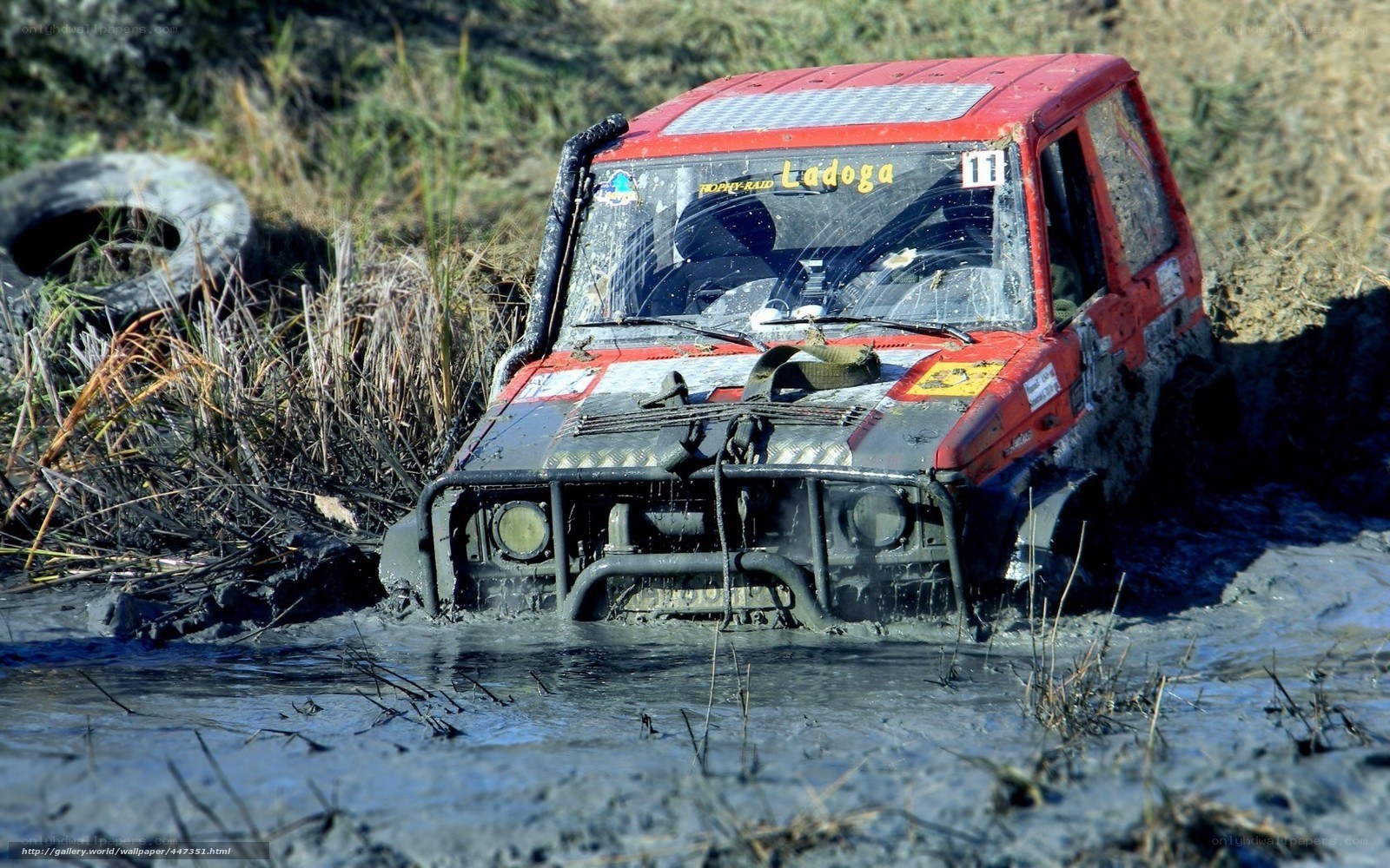 Red off-road vehicle in mud